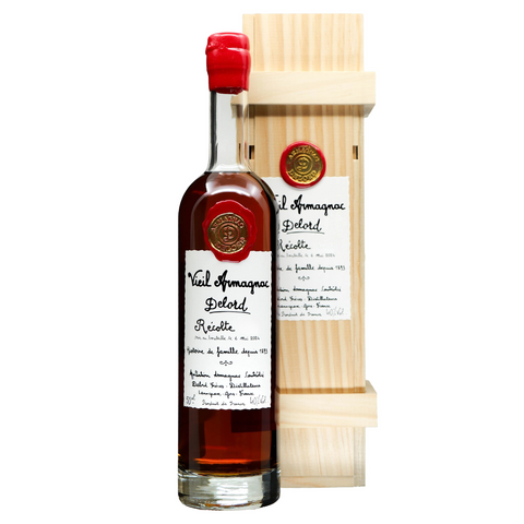 Bottle of Delord Armagnac with wooden box on a white background